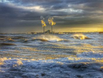 Scenic view of sea against cloudy sky