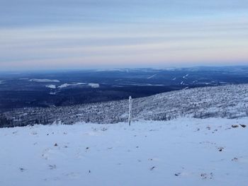 Scenic view of snow covered landscape against sky