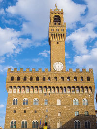 Low angle view of clock tower against sky