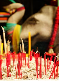 Close-up of multi colored candles in temple