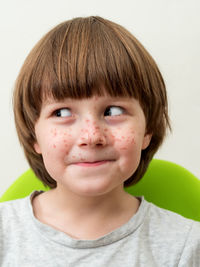 Close-up of smiling boy looking away while making face