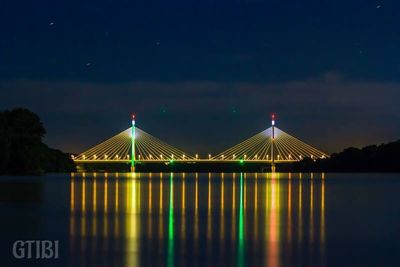 Illuminated bridge at night