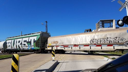 Cars on built structure against clear blue sky