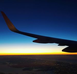 Cropped image of airplane flying over sea