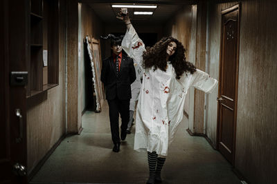 Woman standing in corridor of building