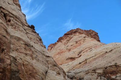 Low angle view of rocky mountains against sky