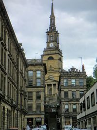 Low angle view of building against cloudy sky