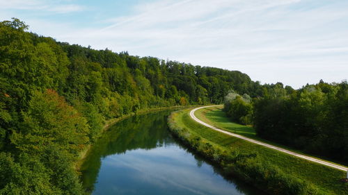 Scenic view of lake amidst trees against sky