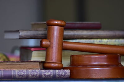 Close-up of books with gavel on table