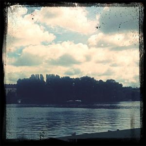 Scenic view of lake against cloudy sky