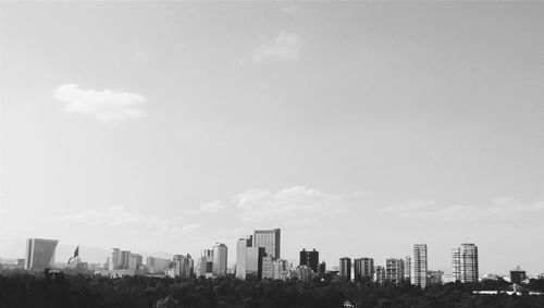 Cityscape against cloudy sky