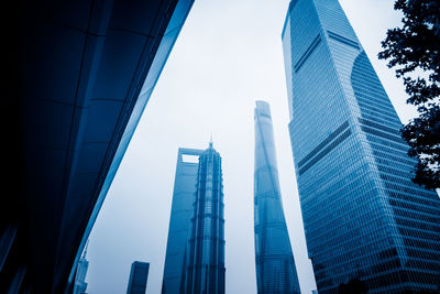 Low angle view of modern buildings against clear blue sky