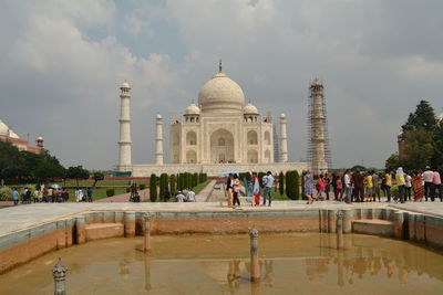 Tourists at monument against sky