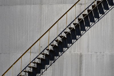 Low angle view of spiral staircase against wall