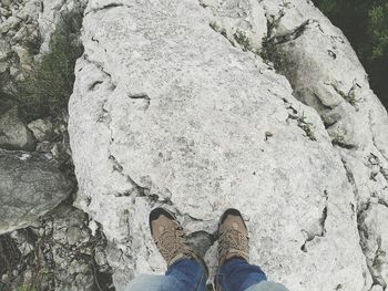 Low section of man standing on rock