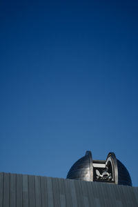 Low angle view of building against clear blue sky