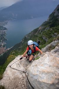 Boy on rock by mountains