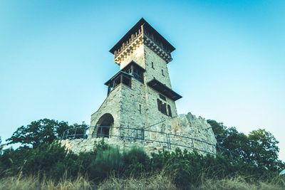 Low angle view of tower against clear blue sky