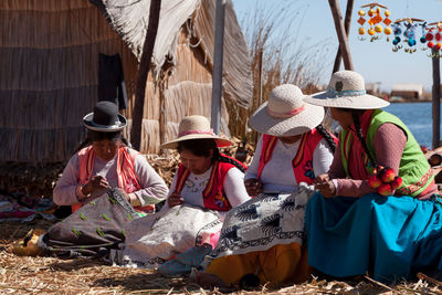 People sitting in traditional clothing