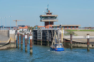 View of pier over sea against buildings