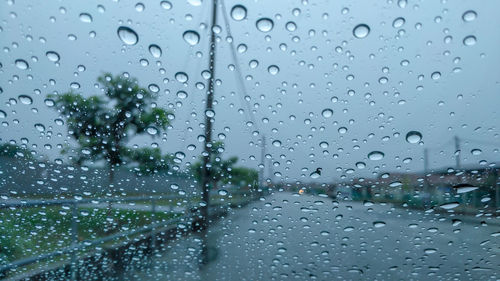 Full frame shot of wet glass window in rainy season