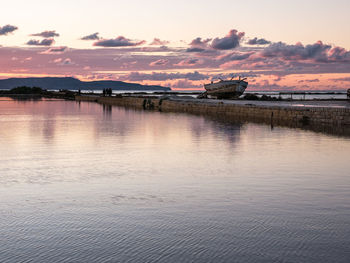Scenic view of lake against sky during sunset