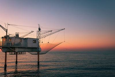 Scenic view of sea against clear sky during sunset