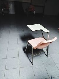 High angle view of empty chair on table