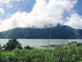 Scenic view of lake and mountains against sky