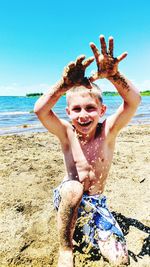 Portrait of happy boy playing on beach