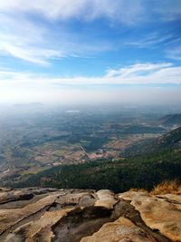 Aerial view of landscape against cloudy sky