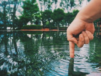 Tilt shift image of person touching water