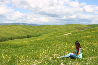 High angle view of woman sitting on field