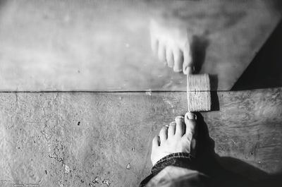 Close-up of woman standing on tiled floor