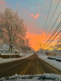 Snow covered road at sunset