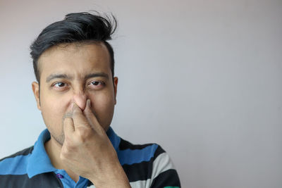 Close-up portrait of man against wall