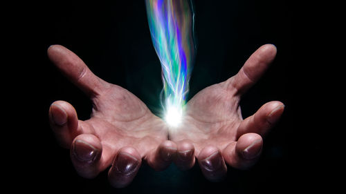 Close-up of hand against black background