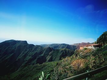 Scenic view of mountains against clear blue sky