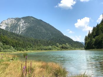 Scenic view of lake and mountains against sky