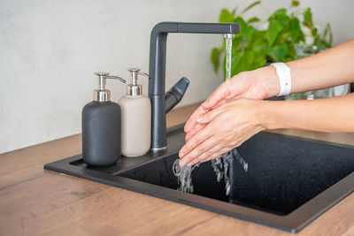 Cropped hand of man washing hands