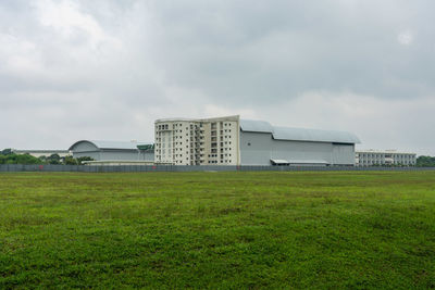 Built structure on field against sky