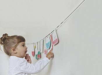 Charming child plays pretending to be a teacher