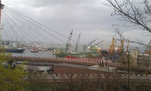 Bridge over river against cloudy sky