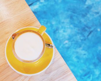 Surface level of drink against blue water