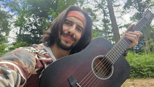 Portrait of man playing guitar