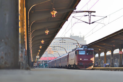 Train at railroad station against sky