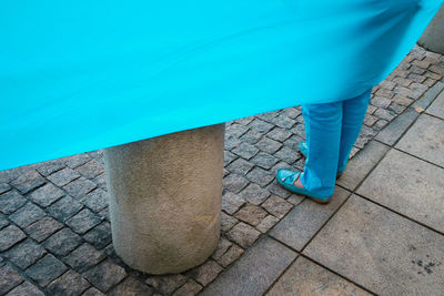 Low section of woman standing on tiled floor