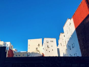 Low angle view of buildings against blue sky