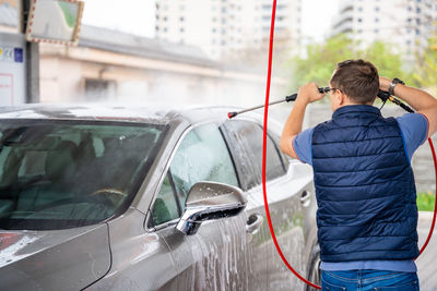 Rear view of woman holding car