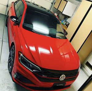 Close-up of red car parked in city